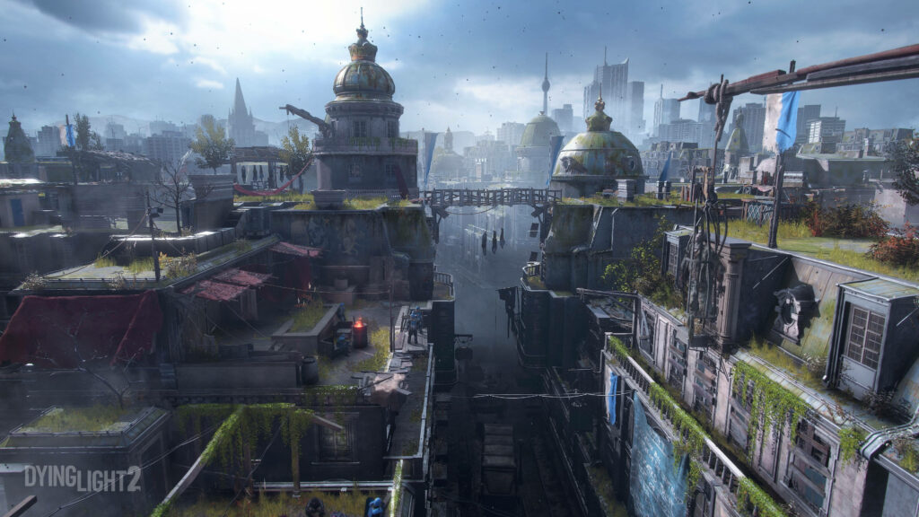 Dying Light 2 wallpaper showing gloomy post-apocalyptic city with crumbling rooftops and vegetation