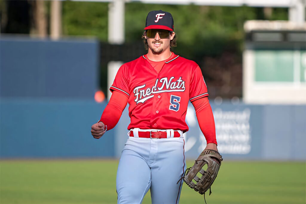 Dylan Crews in red FredNats jersey number 5 poised on baseball field showing athletic focus Wallpaper