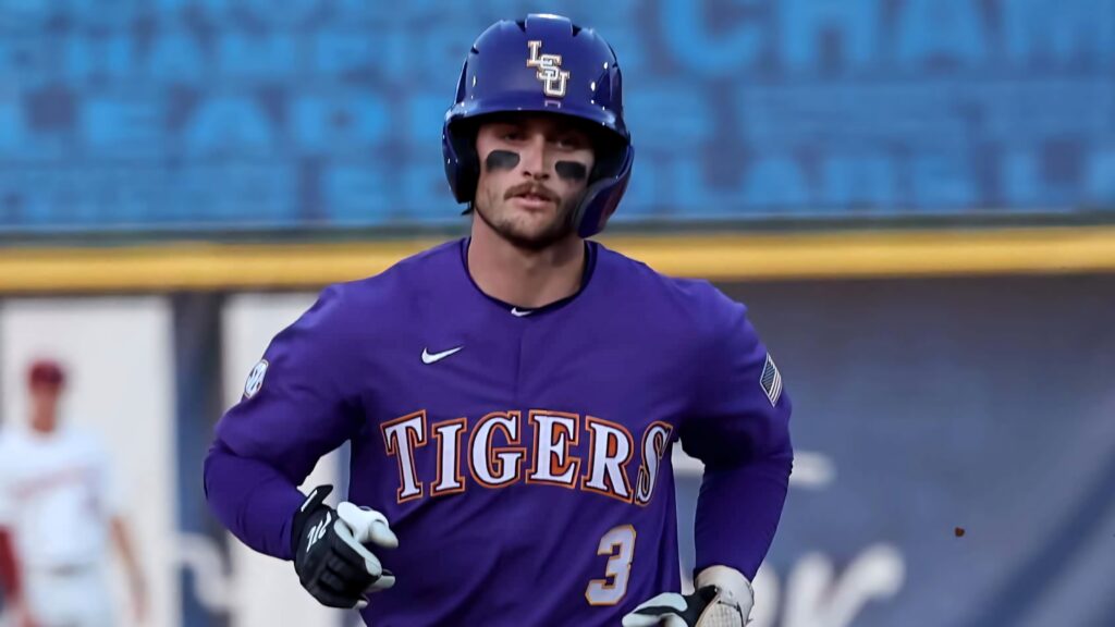 LSU baseball star Dylan Crews in purple Tigers uniform hitting with focused intense expression Wallpaper