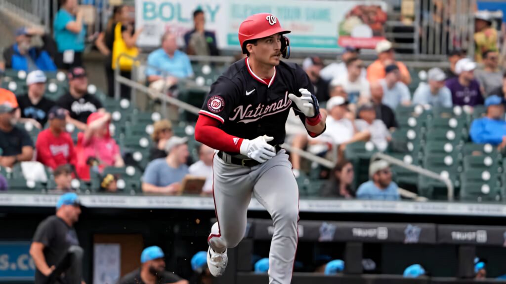 Dylan Crews Washington Nationals running bases in black red uniform vibrant stadium crowd background Wallpaper