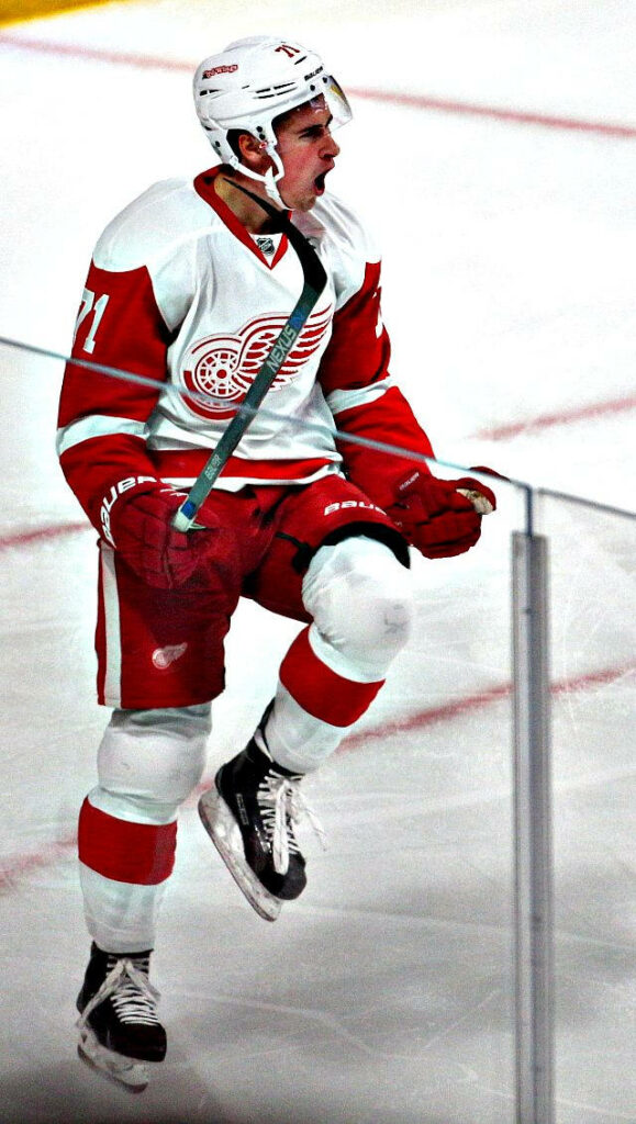 Dylan Larkin Detroit Red Wings number 71 jumping high intense hockey action wallpaper background