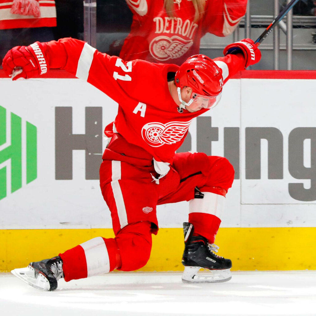 Team Captain Dylan Larkin Detroit Red Wings celebrating intense hockey moment in red white uniform Wallpaper