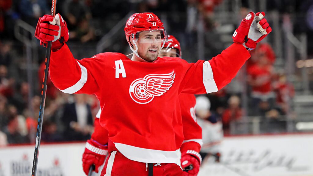 Dylan Larkin Detroit Red Wings captain celebrating on ice in red jersey NHL hockey wallpaper