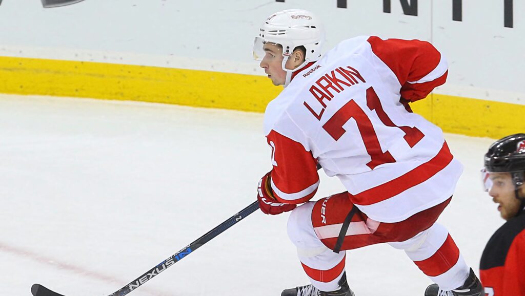 Dylan Larkin Detroit Red Wings hockey player in white red uniform number 71 intense action Wallpaper