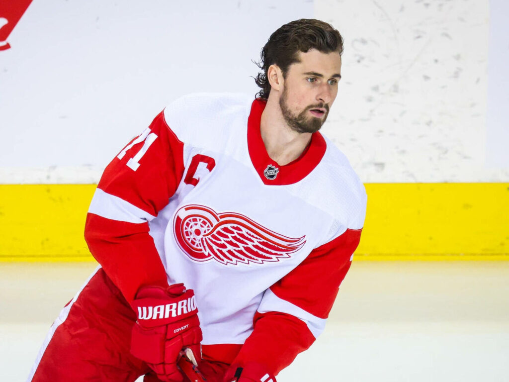 Detroit Red Wings captain Dylan Larkin focused in red white jersey with winged wheel logo wallpaper