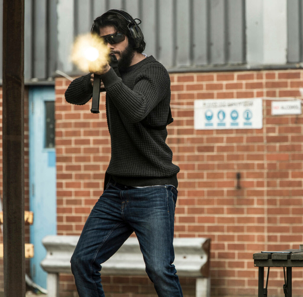 Dylan O'Brien aiming gun intense American Assassin urban training gritty action wallpaper background