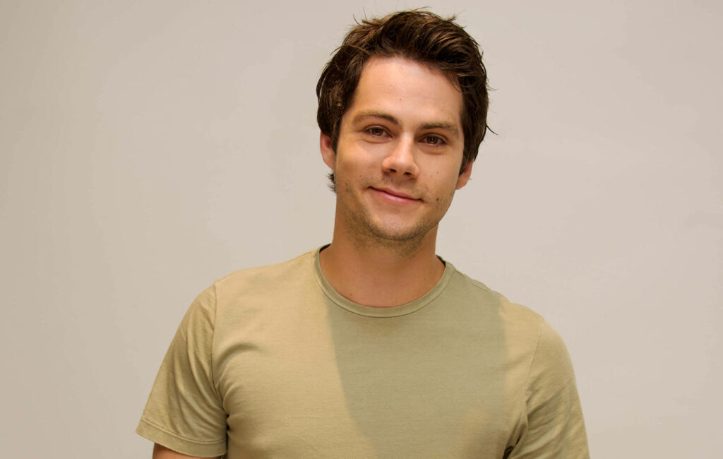 Hollywood star Dylan O'Brien casual pose NME Magazine soft neutral background natural light Wallpaper