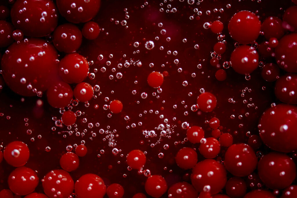 Captivating Glossy Red Spheres Wallpaper with 3D Bubble Effect