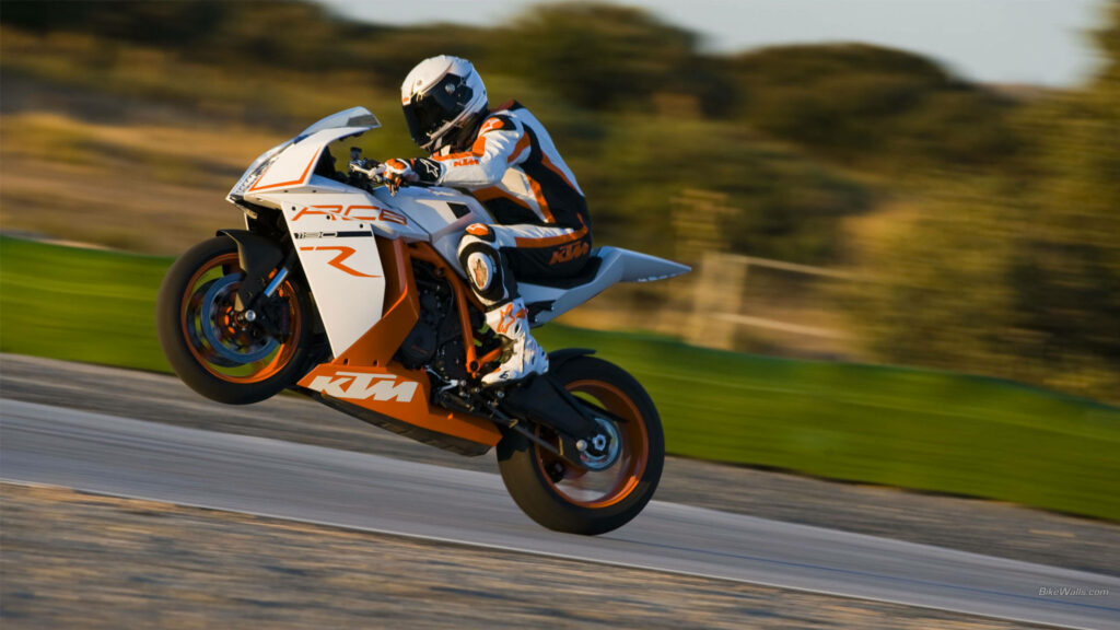 Vibrant 4K KTM Motorcycle Wallpaper - Thrilling Wheelie on Racetrack