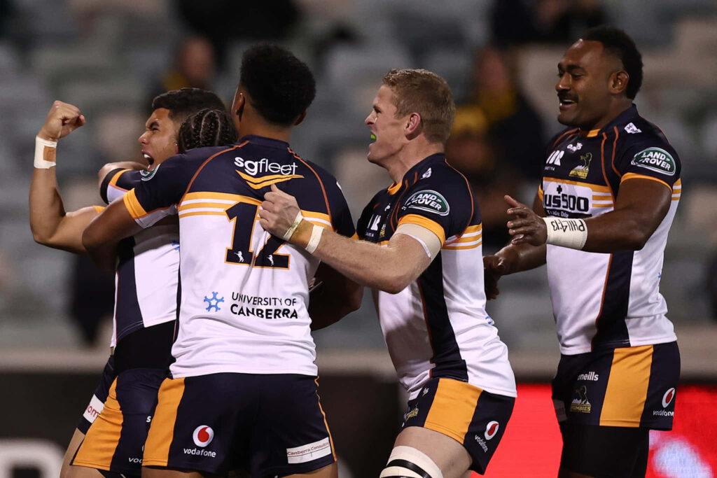 ACT Brumbies rugby players in navy gold white uniforms in action on field Super Rugby wallpaper