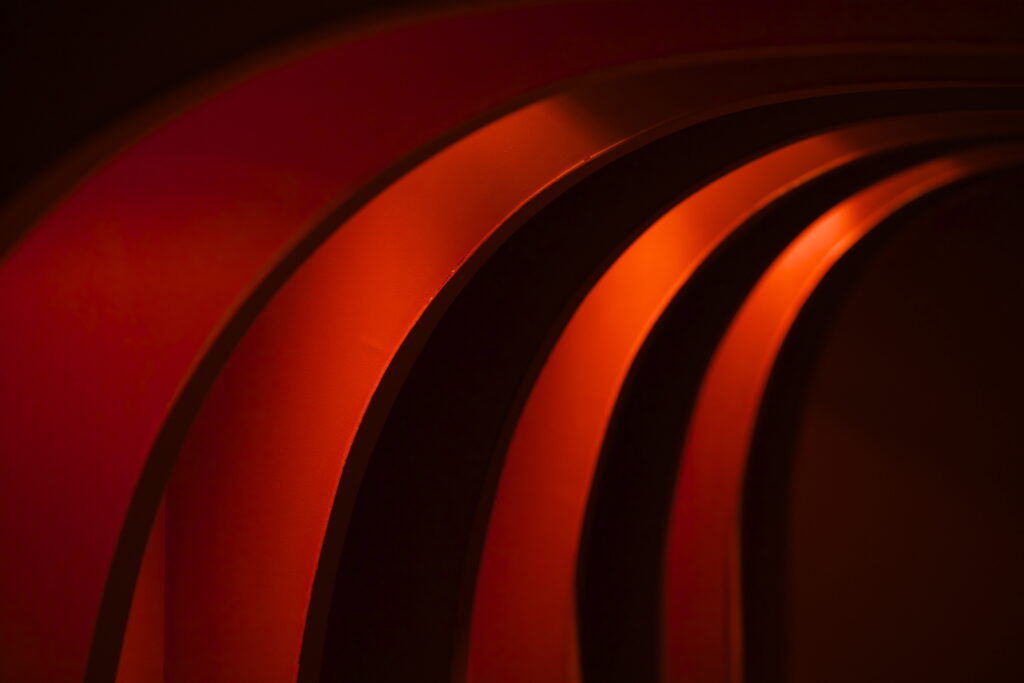 Dynamic Abstract Wallpaper with Flowing Red Curved Stripes
