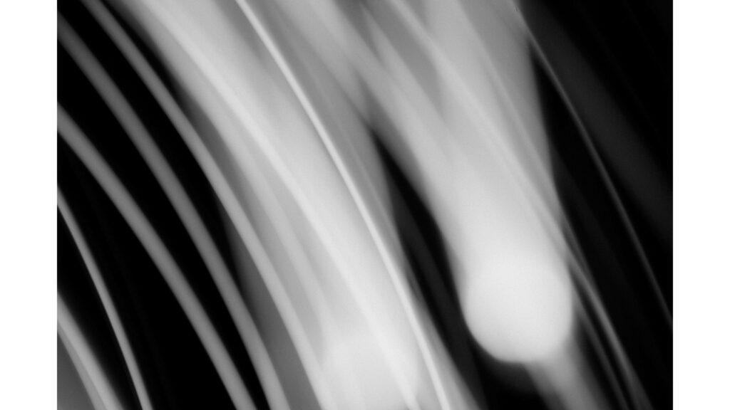 Dynamic Abstract Wallpaper: Flowing White Lines on Dark Background