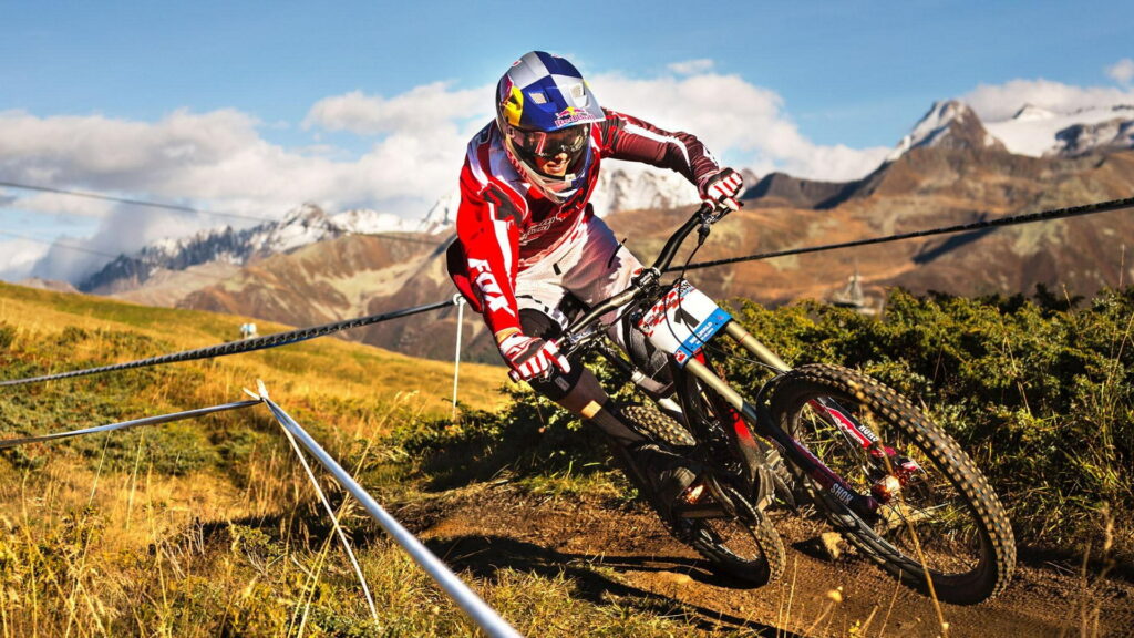 Thrilling Ride: Conquering Curves on a Black and Red Hardtail Mountain Bike Wallpaper