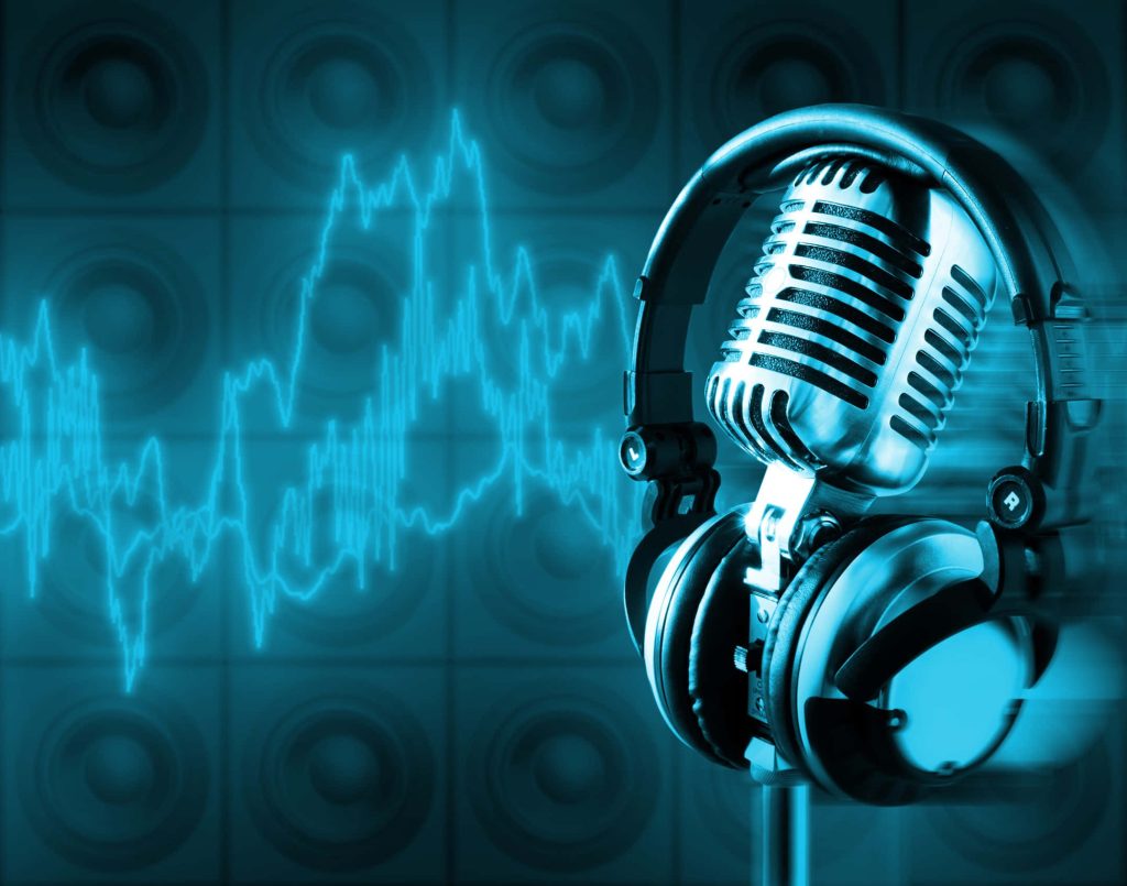 Silver microphone and studio headphones with cyan sound wave speaker background wallpaper