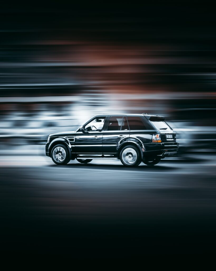 Sleek Automobile in Motion: Dynamic Side View Wallpaper