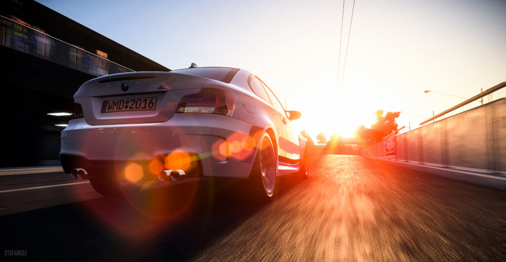 BMW 1 Series M Coupe in Sunlit Motion: Speed & Elegance Wallpaper