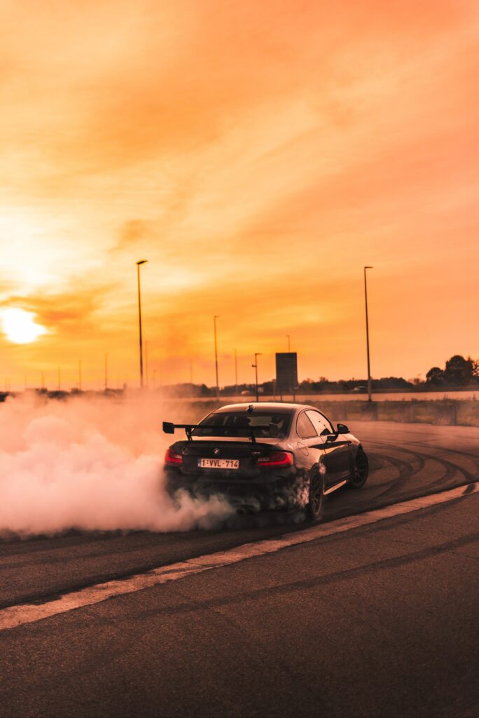 Dynamic BMW Drifting Wallpaper with Vibrant Sunset Background