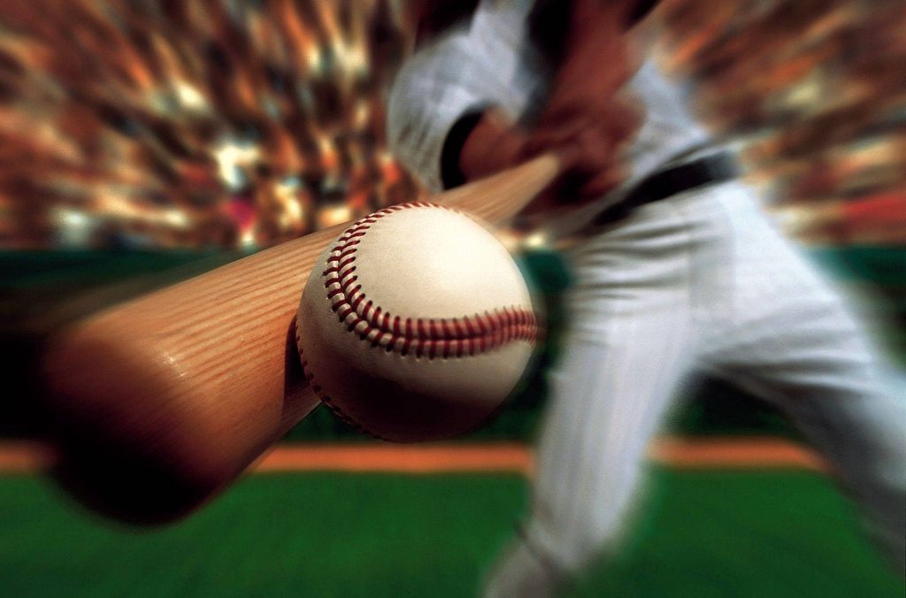 Close-up of wooden bat striking baseball with motion blur vibrant stadium lights wallpaper background