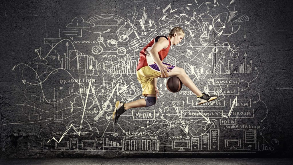 Basketball player dunking over dark wall with white business charts and tech icons background Wallpaper