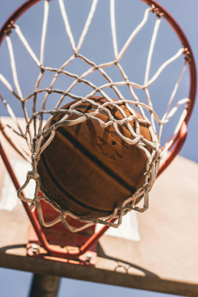 Dynamic Basketball Shot Through Hoop - Aesthetic Wallpaper Background