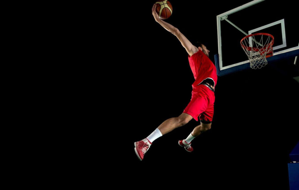Dynamic Basketball Dunk Wallpaper: Player in Red Uniform Mid-Air