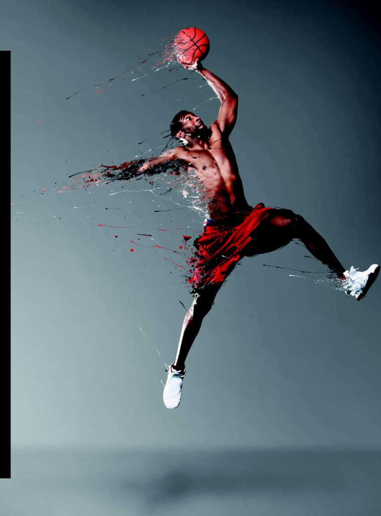 Shirtless basketball player mid-air with red and black particle dispersion effect digital art wallpaper