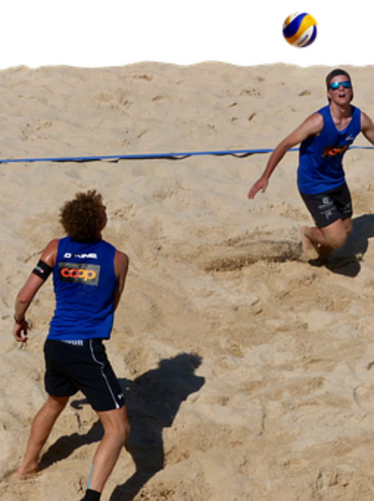 Dynamic Beach Volleyball Action Shot - Mid-Game Wallpaper Background