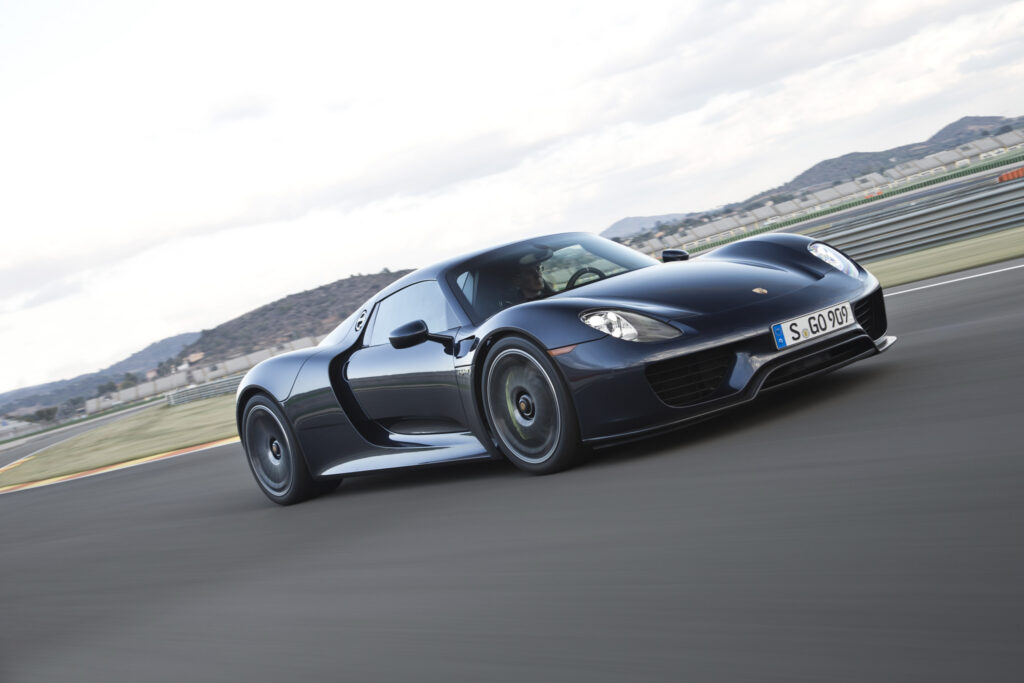 Sleek Black Porsche 918 Spyder in Motion on Racetrack Wallpaper