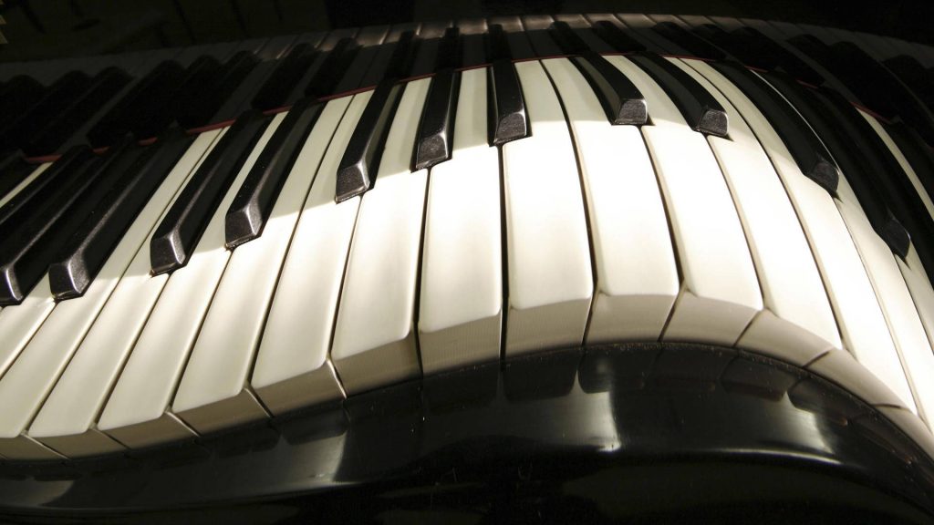 Black and white fisheye piano keyboard wallpaper with dynamic wavy keys for music lovers