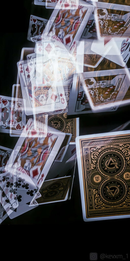 Translucent blackjack cards with gold and red details cascade on dark background casino wallpaper