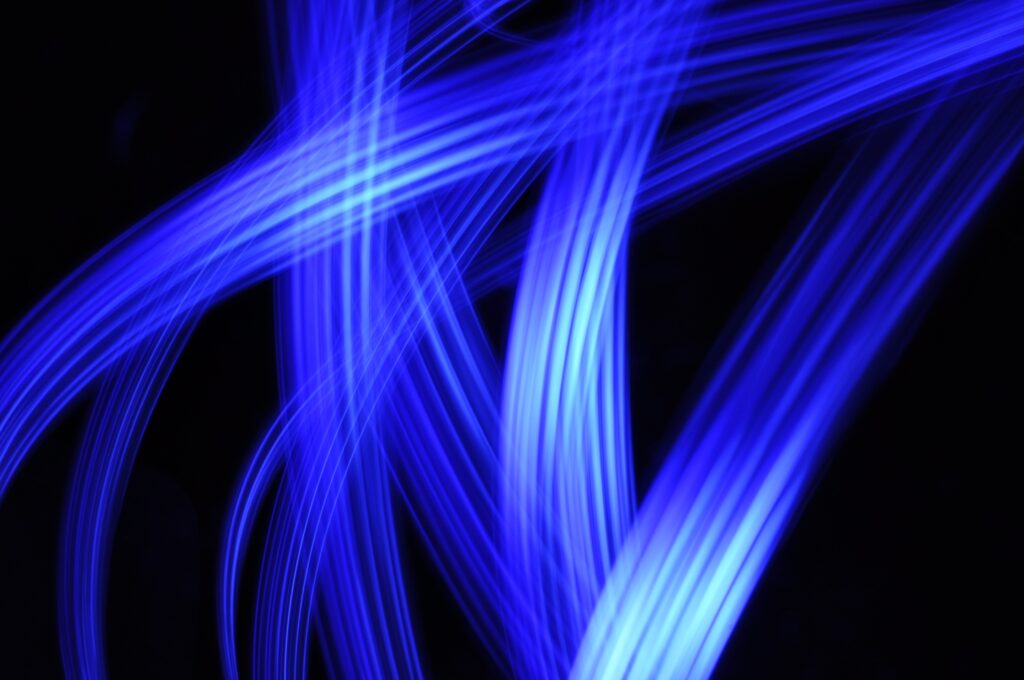 Dynamic Blue Light Streaks on Dark Background - Abstract Wallpaper