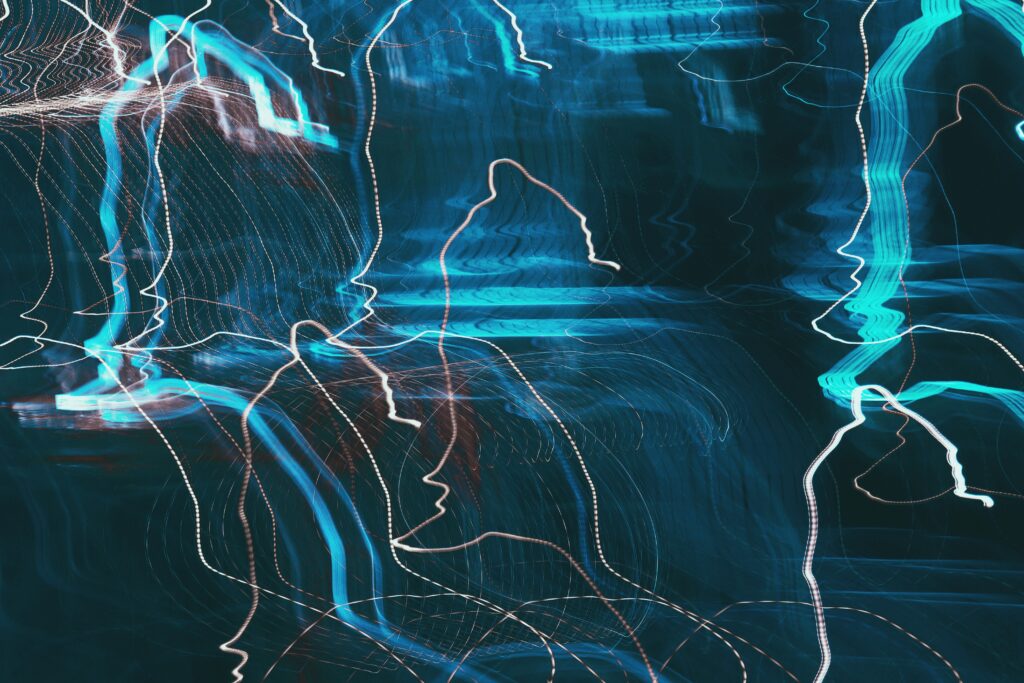 Abstract Long Exposure Wallpaper: Dynamic Blue & White Light Trails