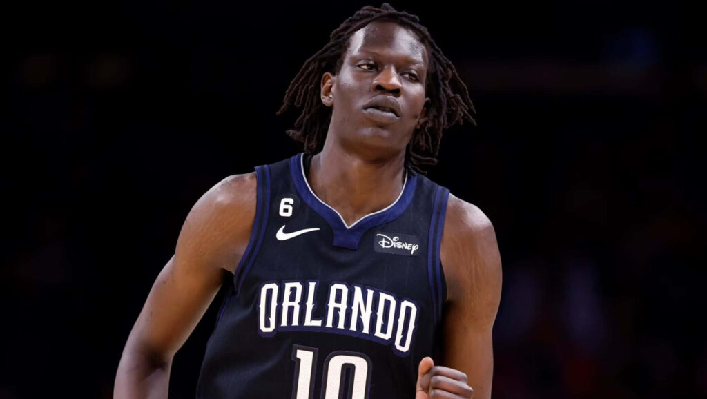 Bol Bol Orlando Magic basketball wallpaper in black jersey dynamic action on dark background