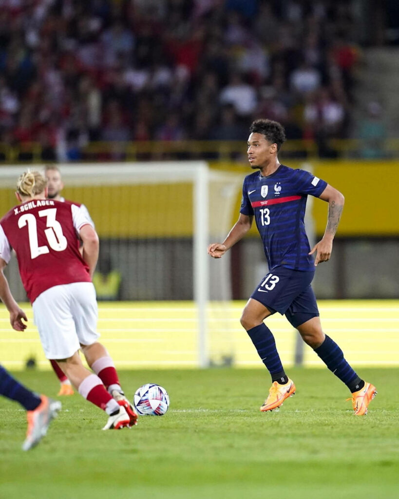 Boubacar Kamara running forward in France kit on vibrant stadium pitch showcasing athletic energy Wallpaper