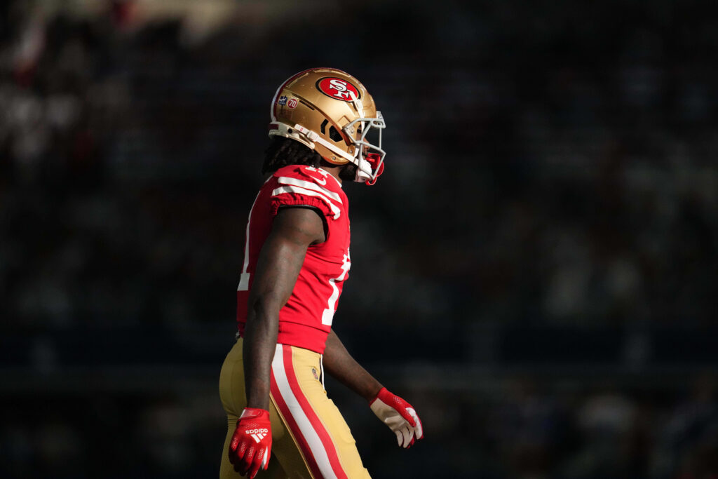 Brandon Aiyuk in vibrant 49ers uniform catching pass in dynamic stadium NFL action wallpaper