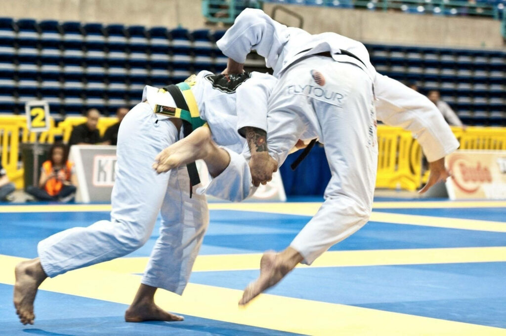 Dynamic Brazilian Jiu-Jitsu Wallpaper: Athletes in Live Action Combat