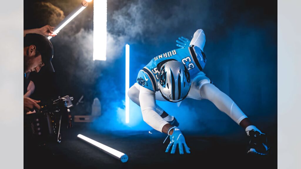 Brian Burns Carolina Panthers football photoshoot with dramatic blue lighting and smoke effects Wallpaper