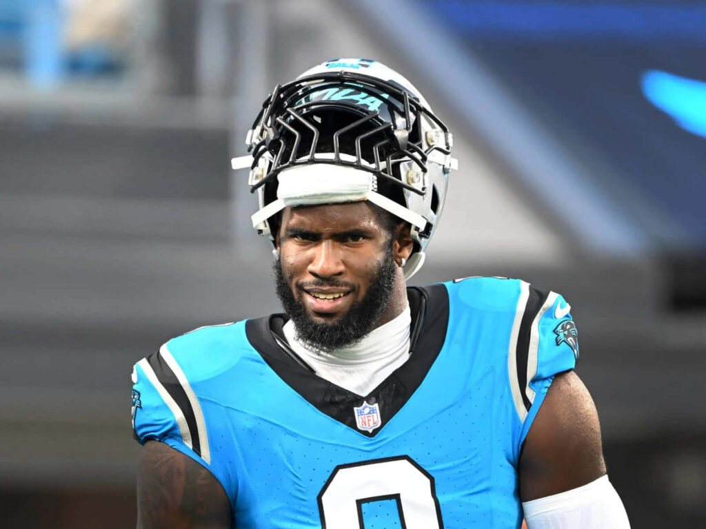 Brian Burns Carolina Panthers vibrant blue uniform dynamic football portrait wallpaper background