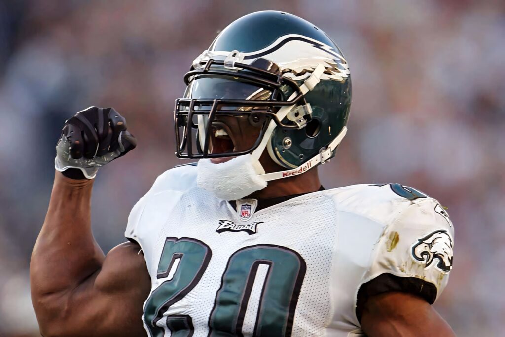 Brian Dawkins in Philadelphia Eagles uniform celebrating passionately with vibrant team colors Wallpaper