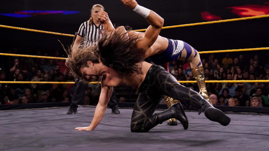 Brian Kendrick and Mansoor intense wrestling action dramatic lighting live audience referee background Wallpaper