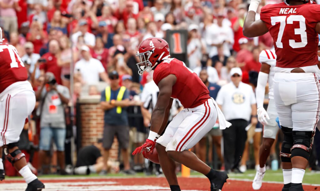 Brian Robinson Jr. football celebration crimson jersey action pose Alabama sports wallpaper background