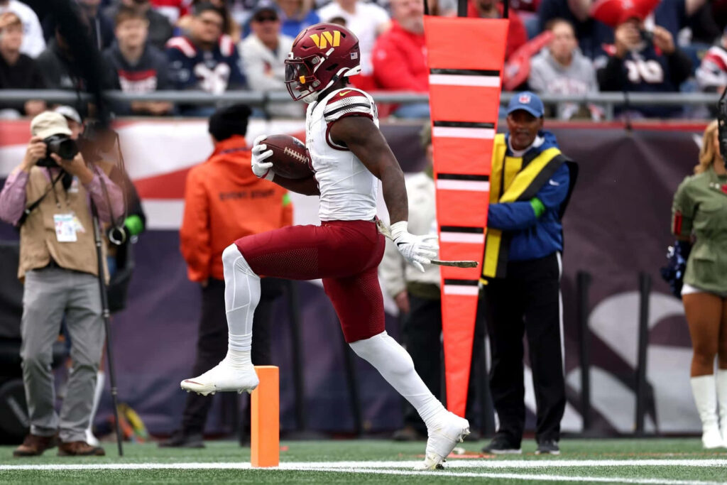 Brian Robinson Jr scoring touchdown in Washington Commanders vibrant colors NFL game action wallpaper