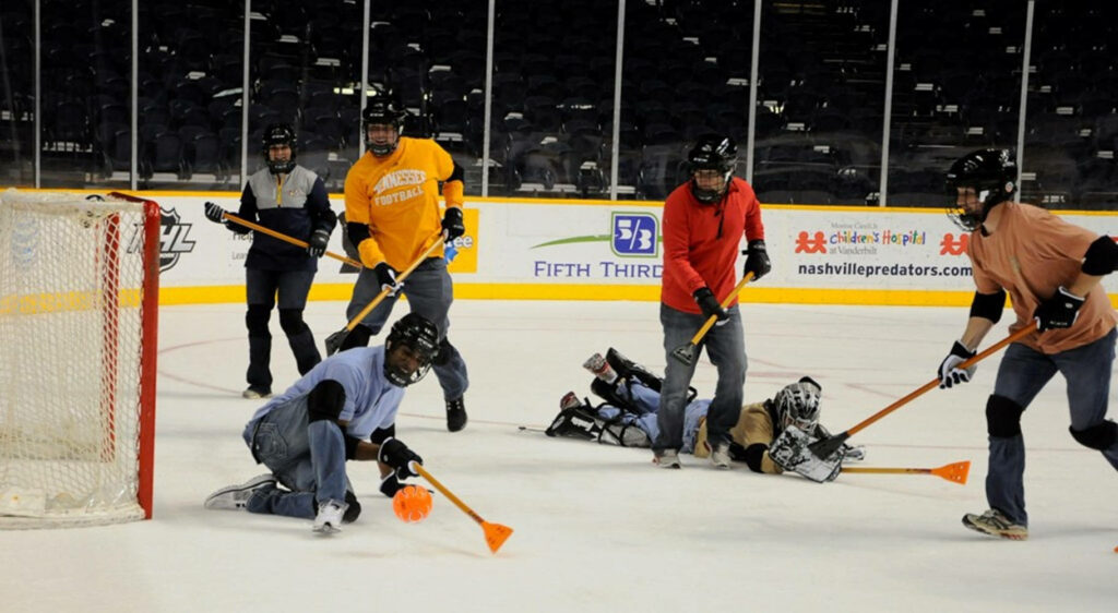 Dynamic Broomball Team Wallpaper: Agility & Teamwork on Ice