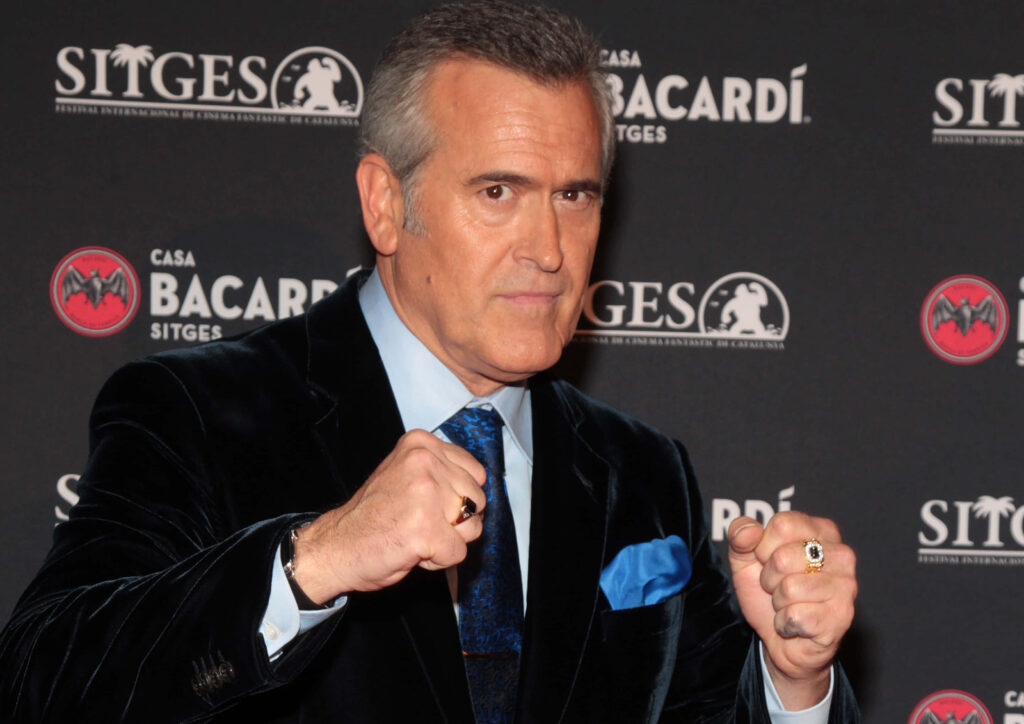 Bruce Campbell fierce pose dark suit Hollywood icon dynamic celebrity wallpaper background