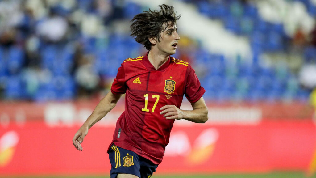 Dynamic Bryan Gil running in red Spain jersey number 17 high resolution football action wallpaper