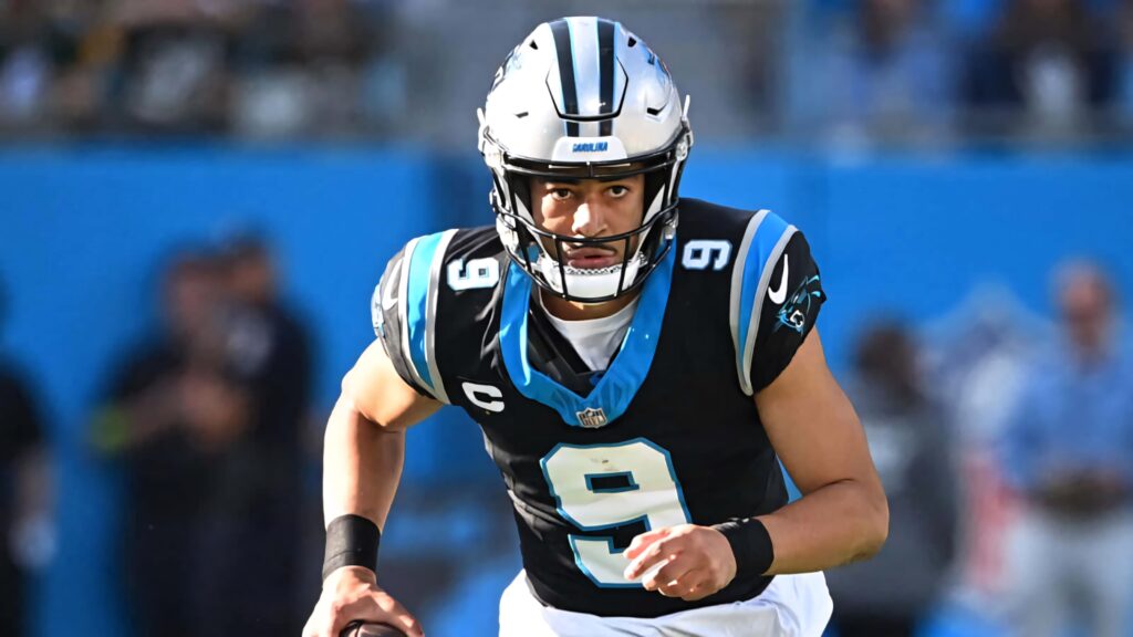 Bryce Young Panthers quarterback mid-play vibrant blue stadium background NFL football wallpaper