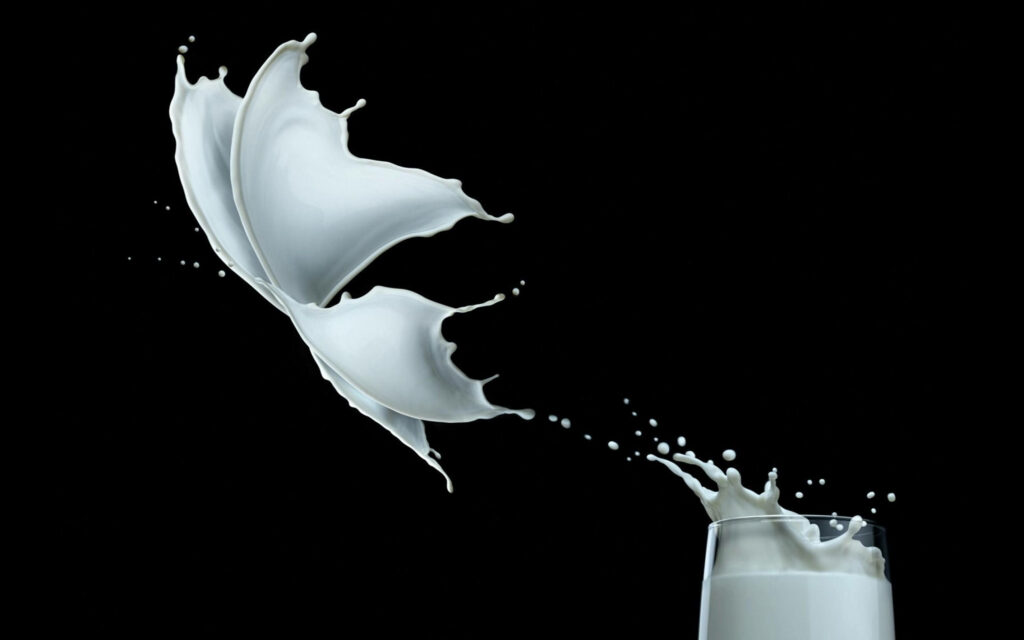 Dynamic Butterfly Splash: Creative Milk Wallpaper on Black Background