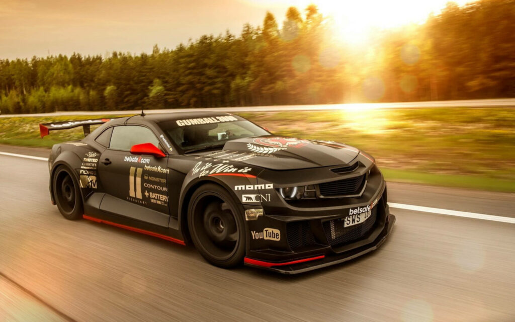 Powerful Camaro Muscle Car Wallpaper: Sunset Road Action Background
