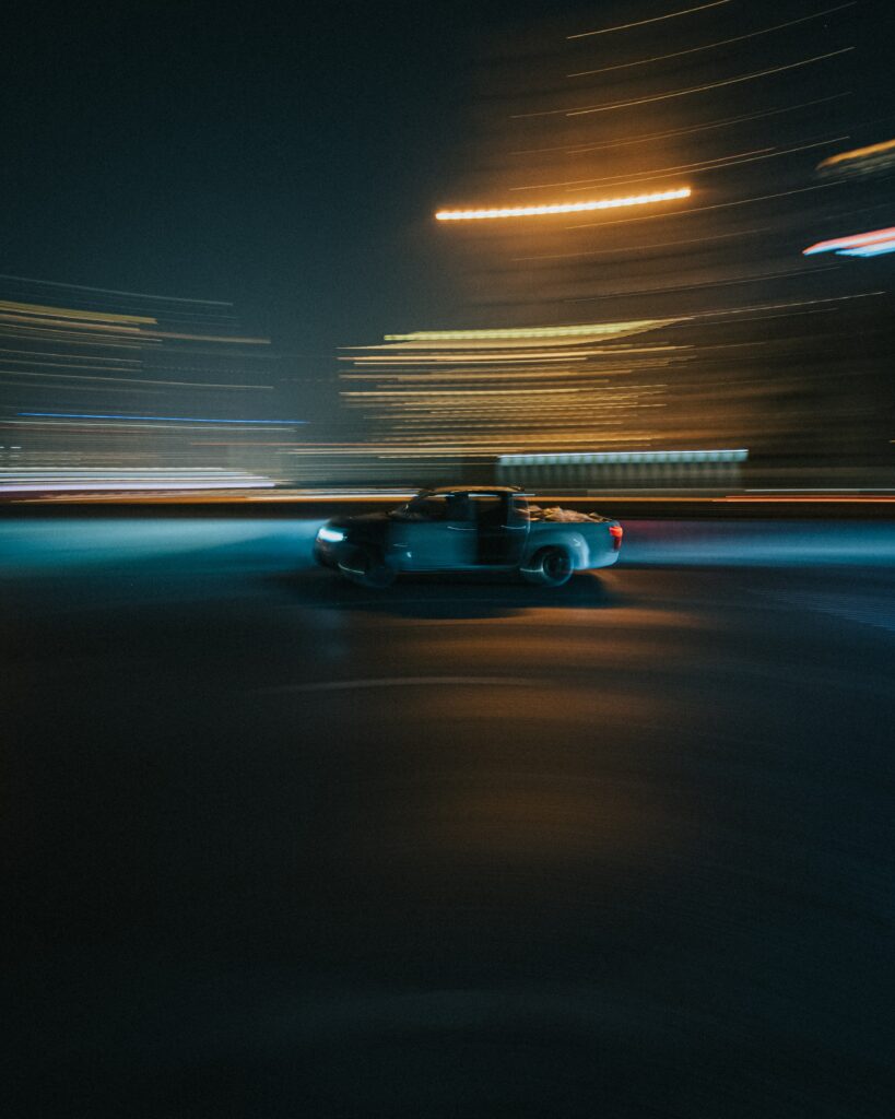 Dynamic Car in Motion: Stunning Long Exposure Night Wallpaper