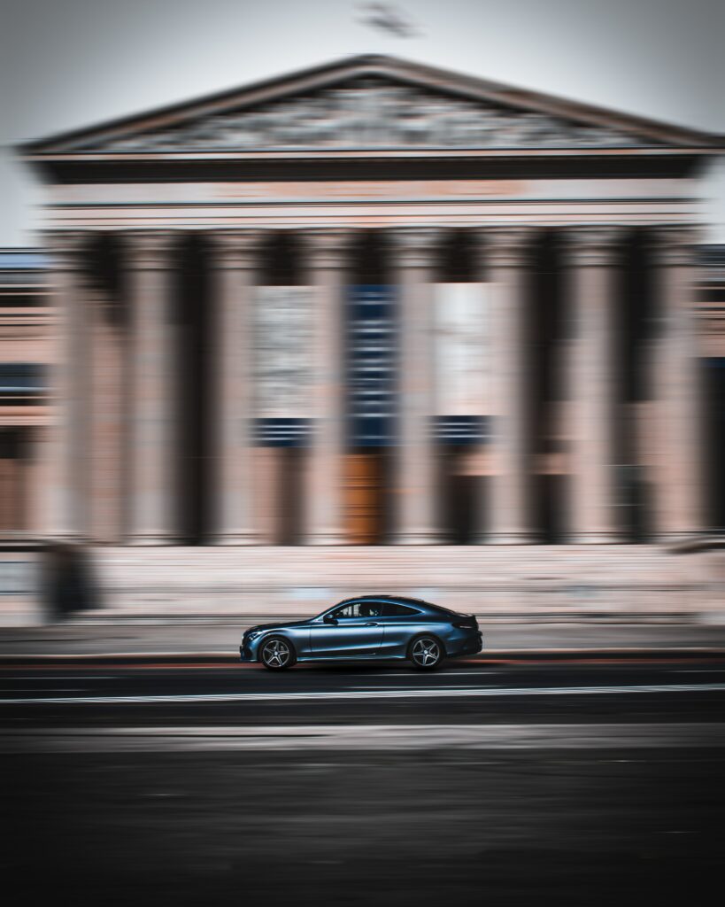 Sleek Car Racing Wallpaper: Exhilarating Speed with Blurred Background